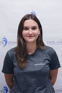 Mia C., entraîneuse de conditionnement physique, portant un t-shirt gris.